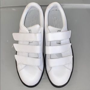 White leather strap puma shoes.